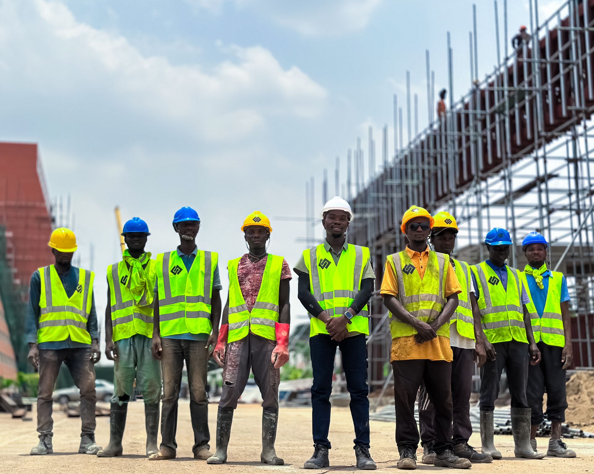 Nigerian construction workers in safety gear at a building site